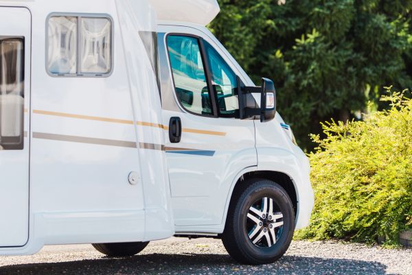 Close-up of a modern white RV parked outdoors