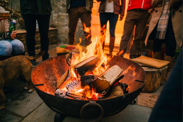 fire-pit-in-the-evening-surrounded-by-people