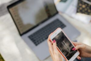 woman-using-phone-and-laptop