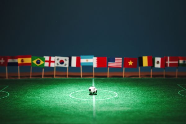soccer field with a ball with different flags